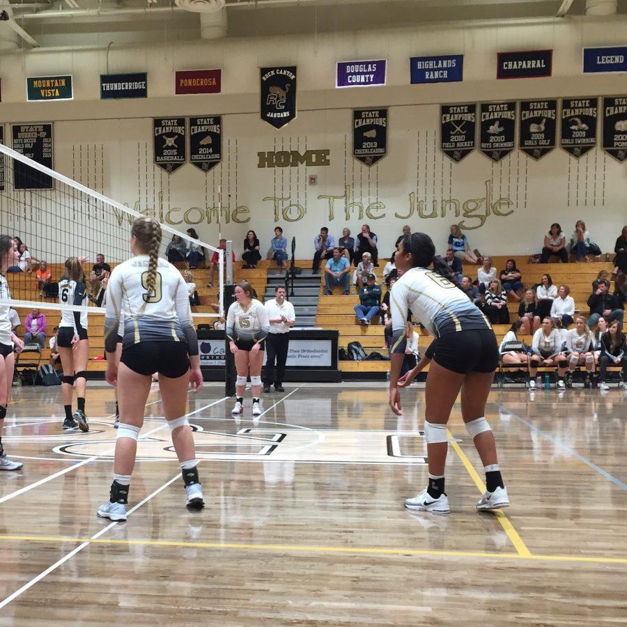 Laryssa Myers 19 and Keeley Davis 18 prepare for the opposing team to serve the ball.
