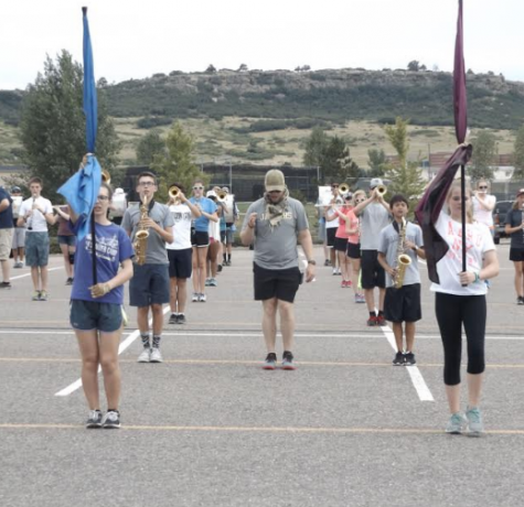 Marching Band gets into formation while band directer Mr. Unger reviews positions during practice at Rock Canyon. 