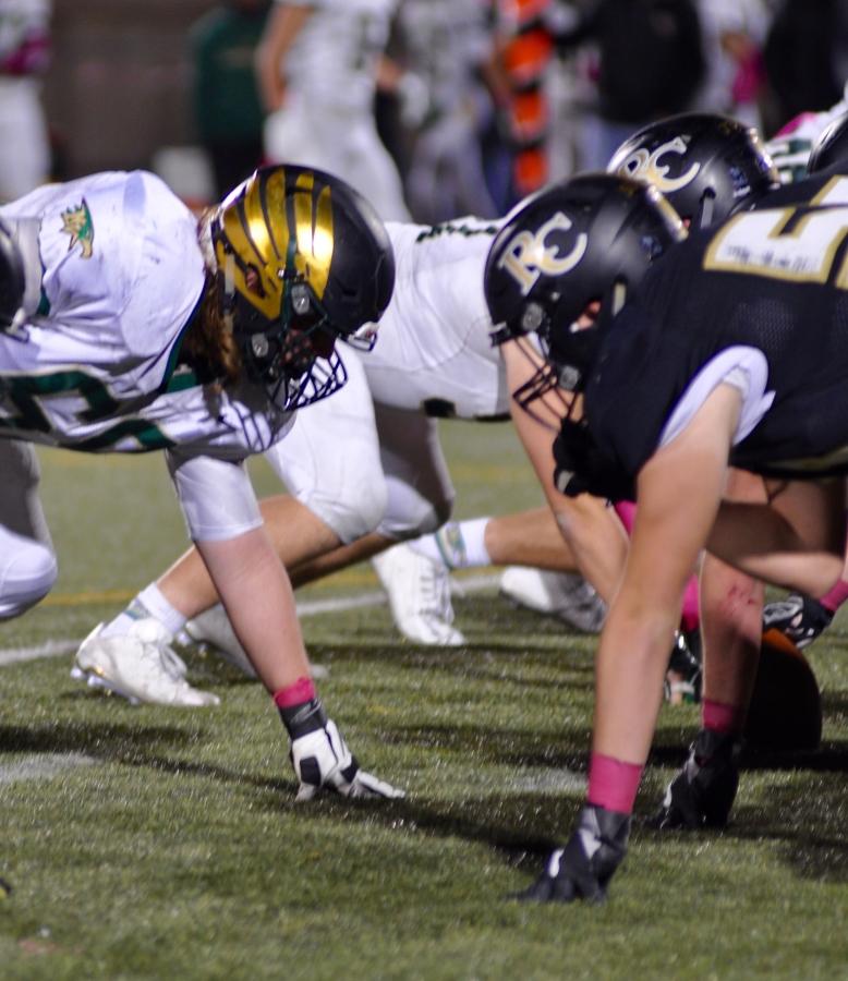 Varsity football players line up before the snap during the Pink Out game against Mountain Vista at EchoPark Stadium, Thus. Nov. 5.