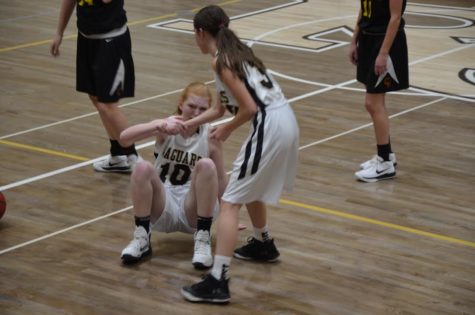 Guard Rebecca Lindsay ‘21 grabs point guard, Josie Gibson’s ‘21, outstretched hand to help her up during  girls c-team basketball game, Tuesday, Feb. 13.  

