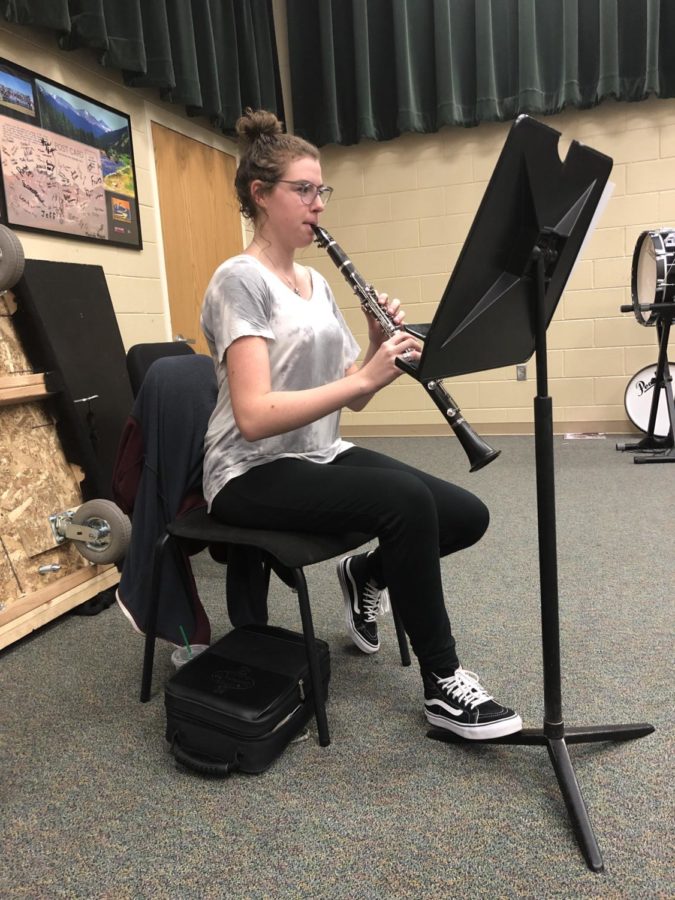 Emily McDonald ‘19 practices her clarinet during access in the band room Jan. 10. McDonald received the music after being accepted into the Colorado All State band and practiced before the combined musical rehearsals. “I am most excited to meet other players from around the state that have worked just as hard to get here and are just as excited about music as I am. As the best in the state changes, the community of musicians chosen is unique to any year prior and I’m really excited to meet this years members,” McDonald said. 
