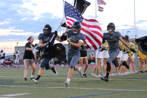 Kade Ramsey 20 and Sean Hicks 20 burst through the homecoming banner and sprint on to the field at Echo Park for the Homecoming Game Sept 19. This game against Arapahoe High School ended with a score of 24-12. “Were losing the game so far, but our school spirit is strong,” Shwetha Suresh ‘22 said.