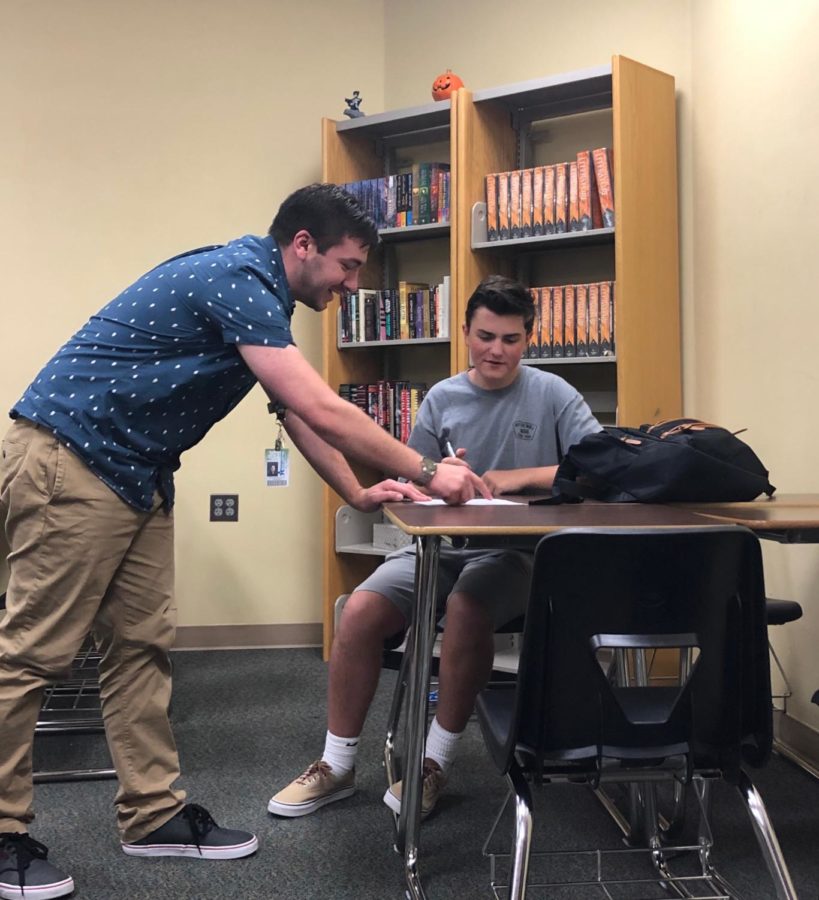 English teacher Pete DeFilippo gives student Owen Kraber '23 direction on an assignment during access in room 3000A Sept. 4. 