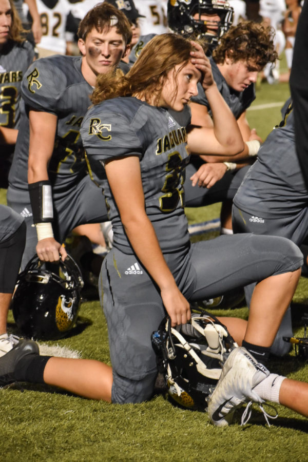 Josie+Manning+%E2%80%9822+kneels+with+her+team+for+an+injured+player+during+the+Homecoming+football+game+at+Echo+Park+Sept.+20.+Manning+and+her+teammates+lost+the+game+against+Mountain+Vista+24-12.