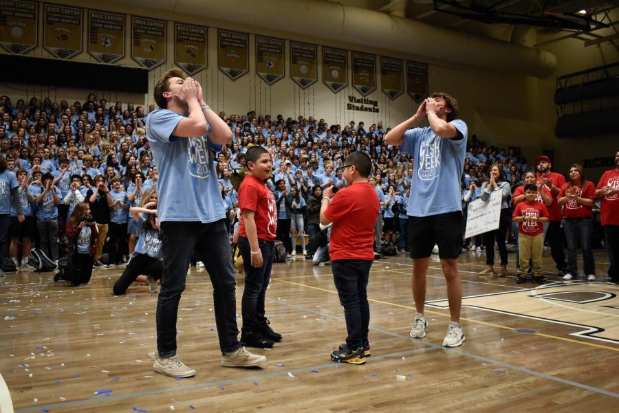 Golden boys Dani Haddad and Cody Lange ‘20, along with Wish Kid Fabian and his brother Carlos, lead the student body in chanting, “I believe in Fabian’s wish,” at the closing assembly Feb. 28. Fabian joined in leading the chant after student council presented the Make A Wish Foundation with the money raised throughout the week.