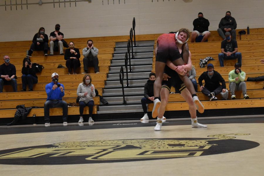 Jack Cuthbert ‘22 lifts his opponent during his match Feb. 20. Cuthbert lifted his opponent several times before losing his match. It’s tough coming back from two weeks of quarantine but you just got to give it all you got,“ Cuthbert said.