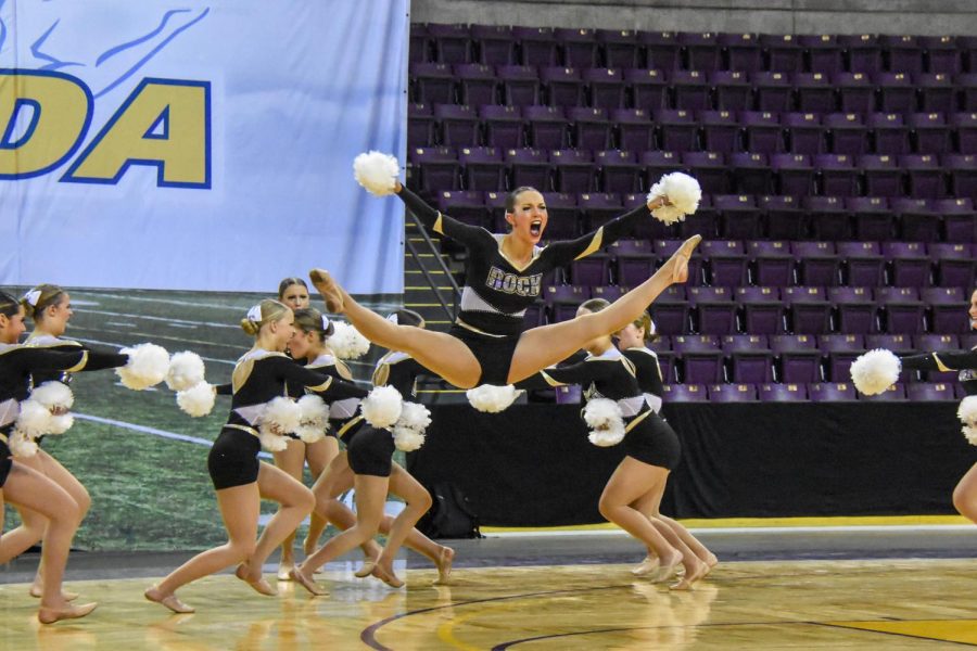 Aalyiah Kikumoto ‘22 jumps during the Varsity Poms team State performance. 