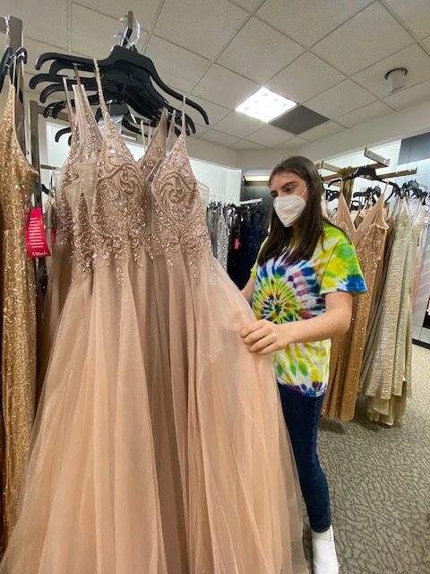 
Ava Schneiderman ‘21 looks for a prom dress at Dillard’s April 21. Despite the location of Main Event, the student council has decided to keep traditional and formal attire for the event. “I’m glad that it’s still happening. Sometimes dress shopping is a bit of a hassle, but it’s nice to get to dressed up for a night because you don’t really get to wear long dresses,” Schneiderman said.