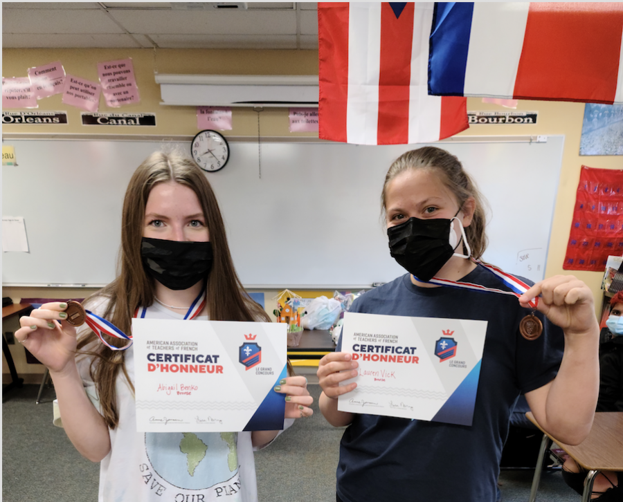 Abigal Benko '23 and Lauren Vick '24 pose with their winnings from Grand Concours.