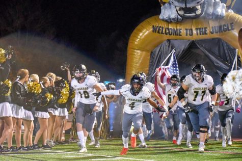 Captains Cole Dreyfuss 22, Croix Burney 22, and Keegan Hamilton 22 run out of the tunnel onto the field to start their first playoff 
 game Friday night. The Jags beat the Smoky Hill Buffaloes 52-49 at the Stutler Bowl in Cherry Creek Nov. 5.