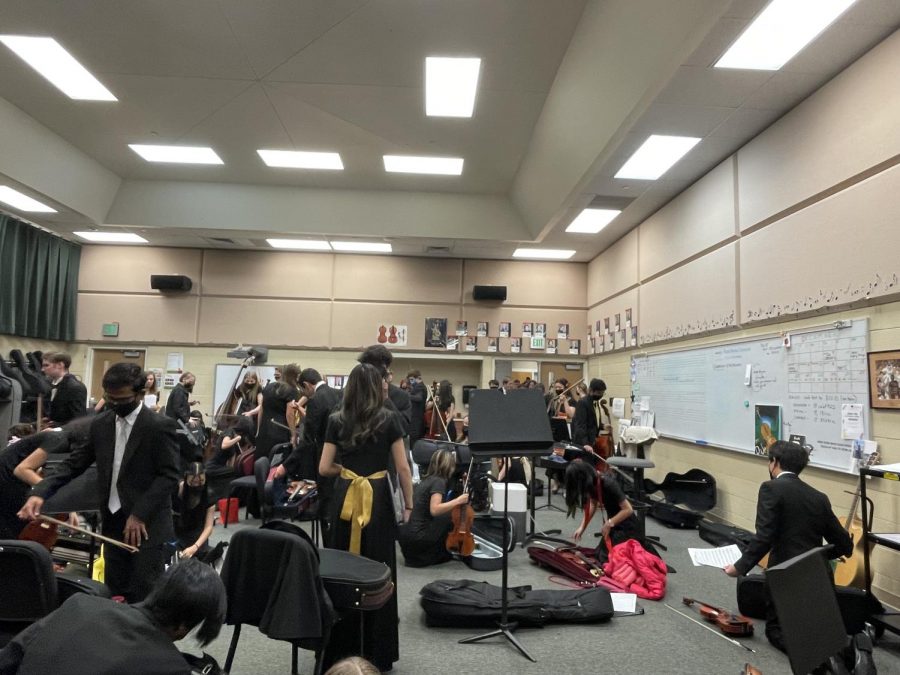 Orchestra students convene in the orchestra room after the concert ends on Dec. 9.