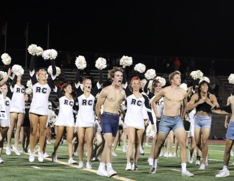 Caden Tisdale ‘22 performs a manpoms dance routine during halftime of the Homecoming Game Sept. 24 at Echo Park.