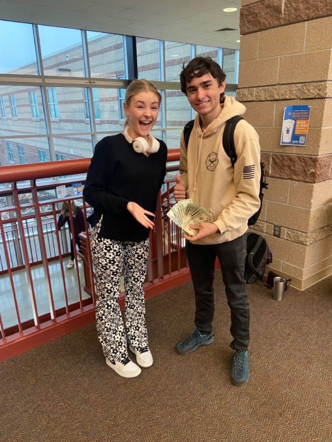 Tiffany Lahey ‘22, who started the game to have an all-inclusive game of senior assassin, and winner, Aidan Hughes ‘22, pose with the prize money after Hughes won the game. After four months the game finally ended when Hughes got the most kills. “Hearing everyone talk about the game in the hallway made me super happy and really proud,” Lahey said. PC. Tiffany Lehay. 
