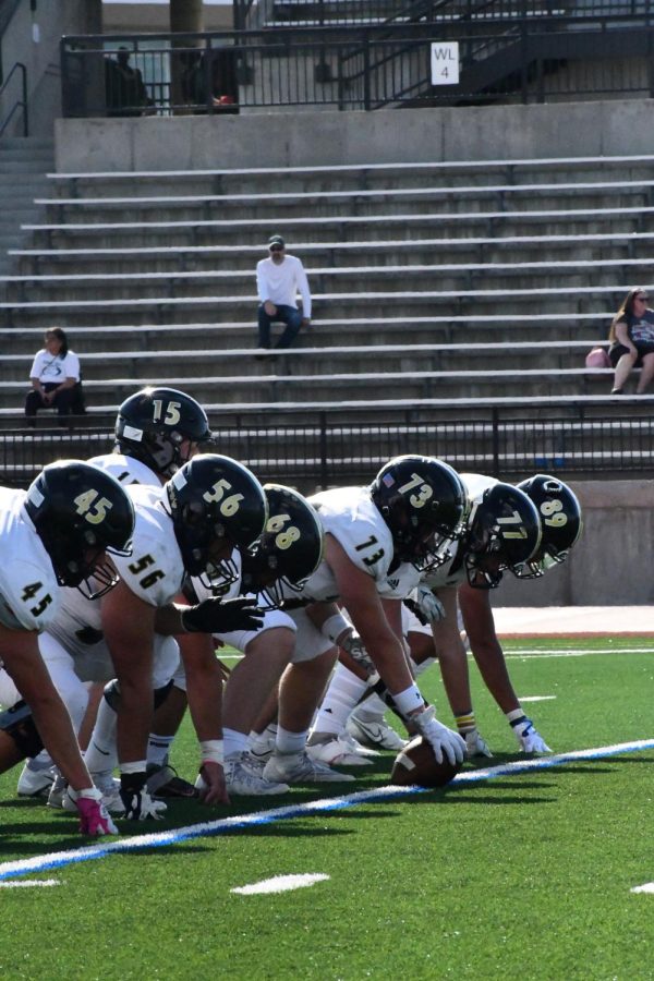 Center, Long Snapper Aaron Moskoff ‘23 practices setting up the ball for a snap to the quarterback Sept. 2. The defensive team stood in line to set up the snap in order to make sure they were aligned and ready for the game. “Personally, I’m very superstitious when it comes to preparing for the game. Every time I warmup, I’ll do three sets of a drill, or do a certain stretch three times. Basically, I like to warm up in sets of threes. It keeps everything consistent,” Moskoff said.