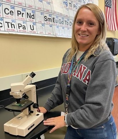 Danielle Harrison poses with a microscope in her classroom Sept. 7. Harrison teaches Biology and Chemistry. "It’s a school. Nothing’s perfect, but I love everything about it," Harrison said.