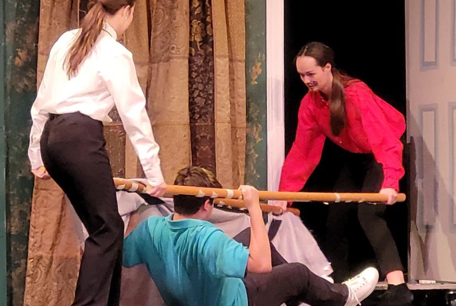 Olivia Potter ‘23 and Eliza Record ‘23 attempt to carry Michael Webb ‘23 offstage on a stretcher during rehearsals for “The Play That Goes Wrong,” Oct. 26. During the show, Webb’s character is shot because he is having an affair with another character’s sister. “[I didn’t feel prepared but] I do now. It took me a while to get here to this point,” Webb said. 