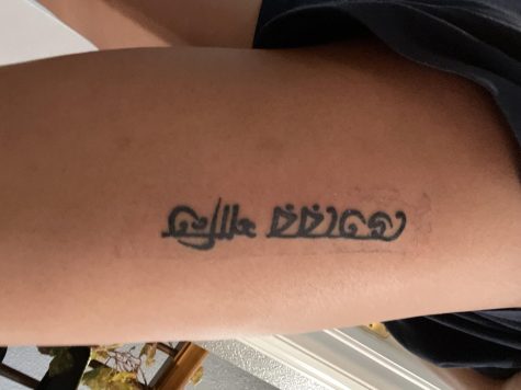Aahana Nandy ‘23 shows off her tattoo on the outside of her thigh. The tattoo says “inner peace” in the language Bengali, and the rest of her family has the same tattoo in different places. “All of us are a little chaotic so it means that even though we’re all chaotic and sometimes argue we still have inner peace within ourselves. It is meaningful because it is with my family and I wouldn’t want my first tattoo to be for anything else,” Nandy said.