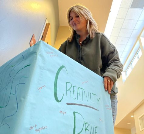 Reagan Synk 23 places a box for the Creativity Drive outside of room 4113 Nov. 18. Synk worked with Morgan Tempel 23, Zella Schnitzspahn ‘23 and Trey Spuhler ‘23 to collaborate with Urban Peak to give to the homeless. “So many people donate the needs, but nobody thinks about the wants. A lot of these kids are just trying to survive and we want to make them feel like they’re more than just surviving, that they can enjoy life,” Synk said.