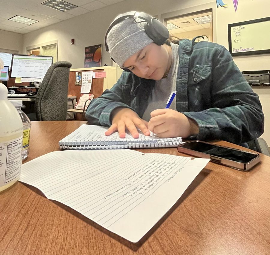 MJ Mejia ’25 works on math homework while listening  to her favorite song, “Neighbors” by J. Cole, during her off period Nov. 17. Mejia has always kept up with her tradition of listening to music while she works on homework throughout the years. “It helps me concentrate and it keeps me calm and it makes me happy,” Mejia said.