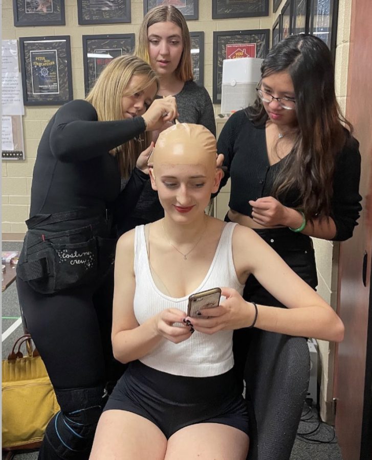Arianna Johnson ‘23, Brooke Schenderlein ‘25 and Eliannah Nguyen ‘25 put a bald cap on Kieran Williams ‘23 for the second act of “Marvin’s Room Nov. 17. The show took place 7:00 p.m. Nov. 16, 17, and 18. Tickets were $10 for adults and $5 for students. Williamss character, Bessie, lost her hair due to chemotherapy treatment for leukemia. “It is weird to see myself without hair, but it was fine. Being bald is a result of chemotherapy and that’s just what Bessie had to go through,” Williams said.
