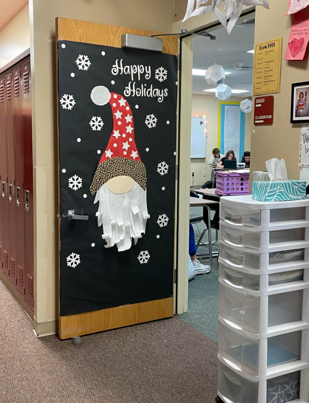 Social Studies teacher Amy Hommel decorated door 5600 with snowflakes and an elf collage.