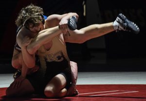 Lifting his opponent, varsity wrestler Matthew Shipley ‘24 finishes a takedown on the opposing wrestler Jan. 11. The dual ended with a score of 43-30 L. “The coaches at Rock Canyon are the best in every way,” Shipley said. “The technique that’s taught is taught very well. The coaches really care about individuals and improving the team, not just winning.”