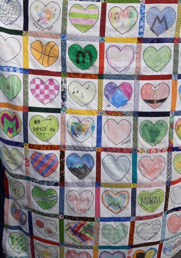 The front of Makai Prices quilt features hearts colored by students Dec. 27.