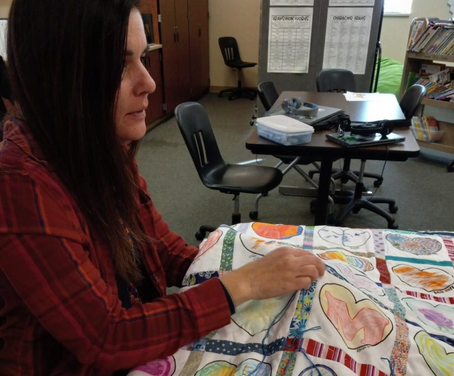 Julie Pedersen ties one of the quilts for the Price family Jan. 31. Pedersen helped to organize the quilt project with her prior knowledge about making quilts. “I love to sew, so it was really fun to do something that’s already my hobby that was for somebody else,” Pedersen said. 