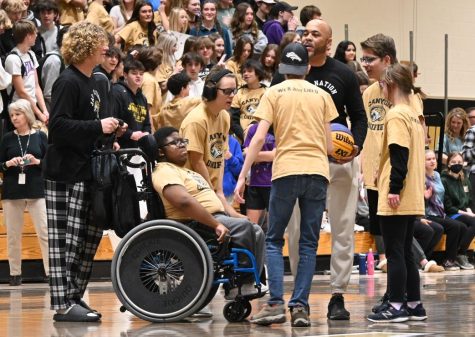 Members of the Unified basketball team plan their strategies Educational Assistant Jerome Price at the annual Unified basketball game Feb. 7. 