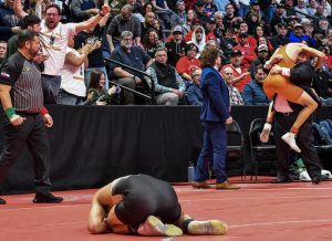 Varsity wrestling captain Sammy Mobly ‘23 lays on the mat after losing the final match at day three of the State Championship at Ball Arena Feb. 18. Mobly wrestled Daniel Long ‘23 of Adams City High School for the 5A 157 pound State Championship and lost 3-1 by takedown in sudden death during overtime, taking second place. “I was honestly just stunned. I knew that was the only chance I’d get at that title, and it was all taken away in just a couple seconds, so it was tough to get the energy to stand up and shake the other wrestler’s hand knowing he just beat me,” Mobly said.