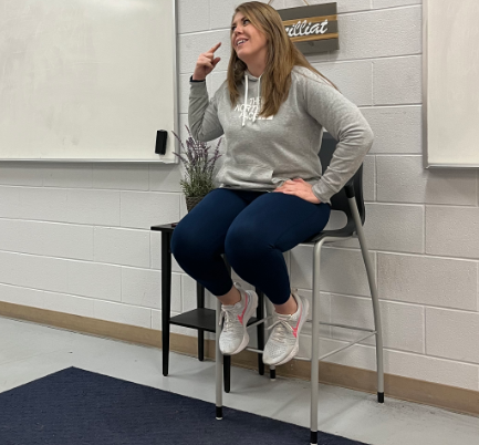 Healthy Decisions and Adventure Experience teacher Christina Marcilliat sits on her chair, talking to some of her students before class starts Feb. 22. Marcilliat explained that she didn't know she was going to go into teaching, but found a love for it when in college. “My degree is in health and I kind of fell into teaching and realized I really liked it,” Marcilliat said. 