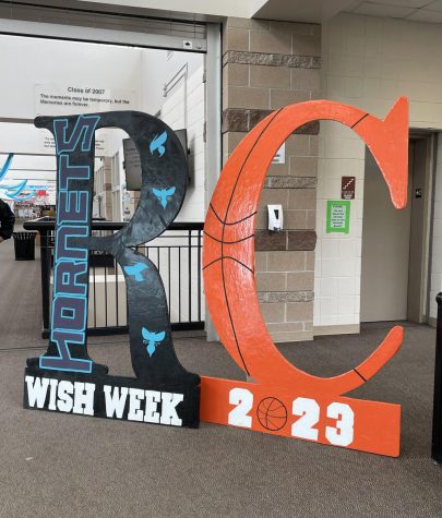 The Wish Week sign is displayed in the upper main hallway April 4. It was decorated with Fidels favorite basketball team, the Charlotte Hornets, and an orange basketball. Wish Week is important because it brings together the entire Rock Canyon community and we get to welcome a whole new family to our community, Student Body President Myles Rubin 23 said.