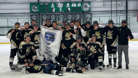Varsity boys ice hockey team holds up the 2023 Wales Division Banner May 14. The team won against the reigning championships, the Denver East Angels, 9-2. It felt amazing. It really showed that, with a full group of guys, with the right mindset, we can do anything, right wing Easton Stockert 25 said. We took down the back-to-back champs, which was my personal first time ever beating Denver East. 