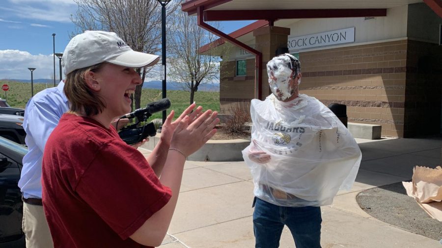 Kristie Vetter 25 claps after pieing U.S. History teacher Wes Chapman May 4. The pieing took place in the outdoor classroom to prevent mess.