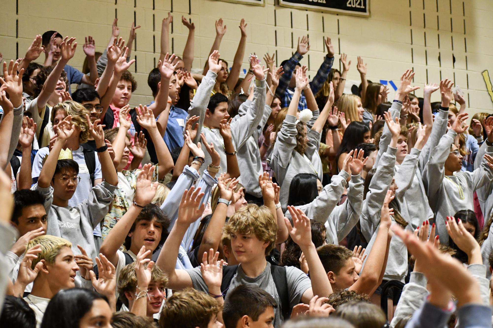 Members of Class of 2027 raise their hands in the air while playing Simon Says during their freshman orientation Aug. 8
