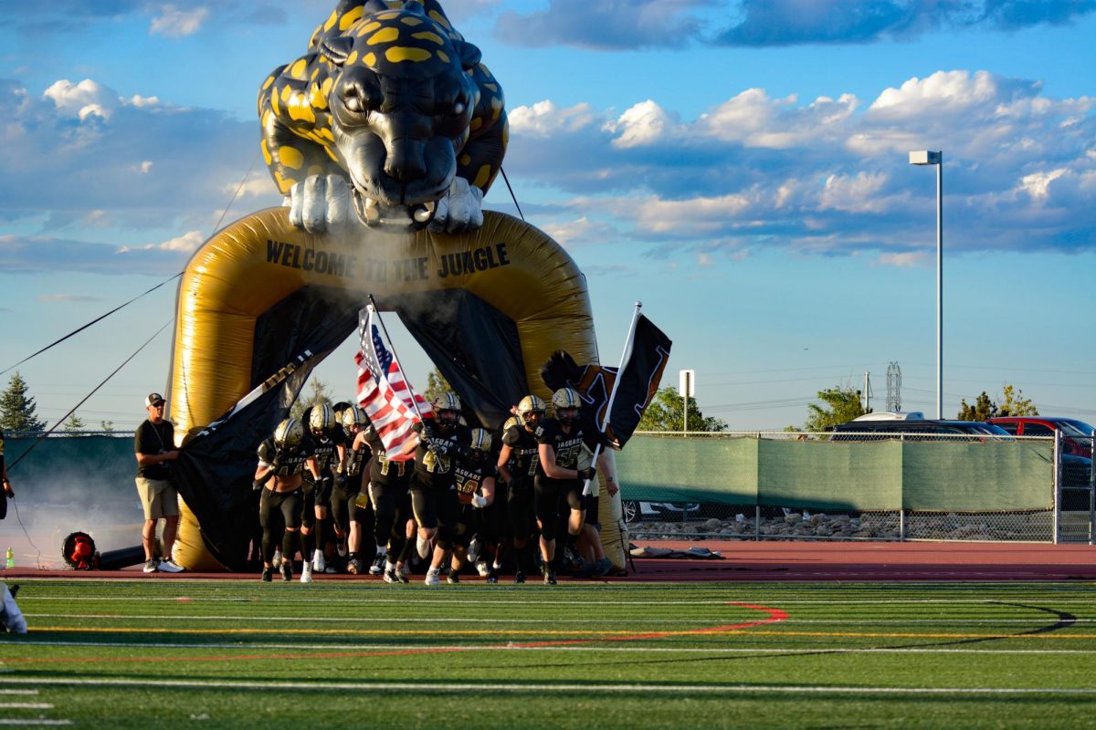 The varsity football team runs out of the “Welcome to the Jungle” tunnel before the start of the home opener against the Smoky Hill High School (SHHS) Buffs Aug. 31. The varsity team was 7-0 after the first quarter and went into halftime with a score of 14-7. The team went on to score another 21 points during the last half. The Jags beat the Buffs with a final score of 42-7 W. “The atmosphere was crazy on the field. The student section and fans kept the energy up, which allowed us to put up 42 on them,” varsity lineman Jake Lenertz ‘25 said.