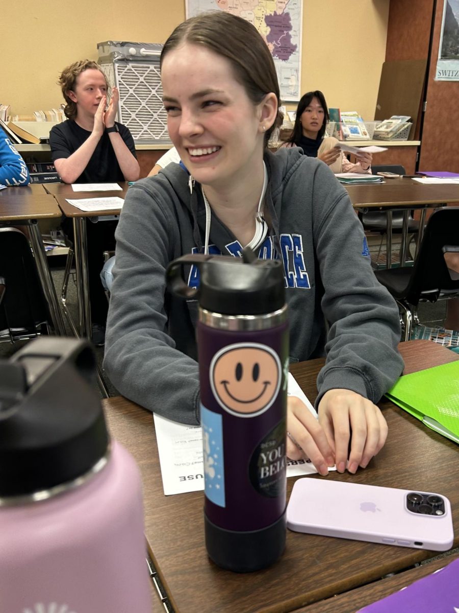 Clara Benko ‘24 laughs while preparing to play a game called “La Personne Précieuse” in AP French Language & Culture Sept. 6. The activity was used to help students get to know each other through the use of interview questions, all in French. “Because we have a combined class, it is often difficult to get to know the people that [aren’t] in your level,” Benko said. “In French, we always say that French is family. This helps us actually achieve that.”