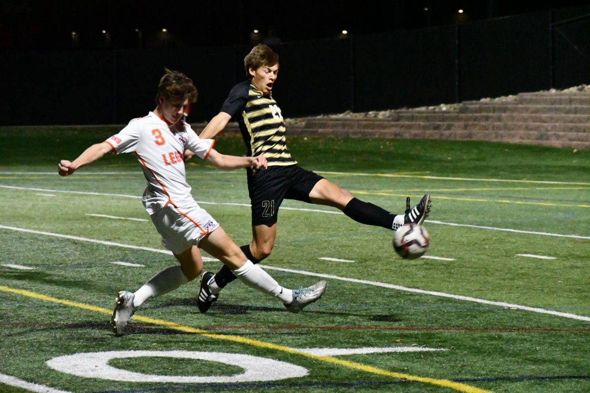 Varsity boys soccer center back Owen Creeden ‘24 holds off Legend High School player during the first half of the game at Halftime Help Stadium Oct. 17. The Jags defeated Legend 5-0.