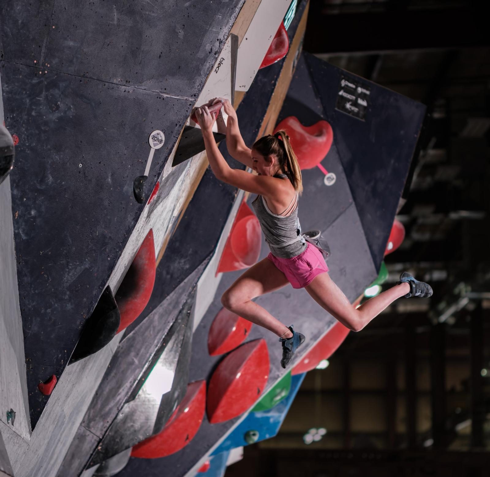 Izzy Orner ‘25 jumps to the next grip during the National Bouldering Championship in Seoul Aug. 27. The National Championship became Orner’s number one priority when she got the chance to compete. “My favorite part about competing was the energy in the crowd for everyone on the wall,” Orner said. 
