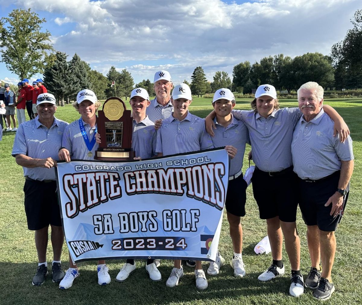 Coach Ron Saul, Charlie Tucker 24, Mason Conrad 24, Coach Dave Vahling, Nick Mayday 24, Nathan Kim 24 and Trey Kahrhoff 24 hold up the CHSAA championship banner on Collindale Golf Course Oct. 3. The team had a total score of 440 strokes, finishing +14 strokes to par. The season has been going great and Im so proud to win with my five seniors, Vahling said. We were all a bit nervous but confident we could win.
