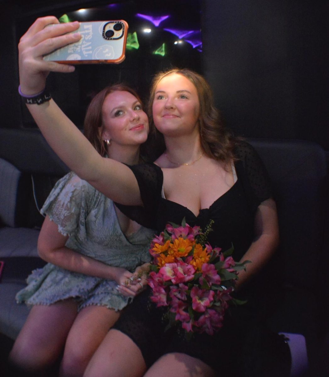 Brooke Hein ‘24 and Hailey Walker ‘24 take a selfie together while riding a party bus to dinner after taking pictures at Cheesman Park Sept. 23. The group took pictures and went to dinner at Maggianos. Later that night, their bus broke down while leaving Top Golf. The group waited 30 minutes for a new bus. “Homecoming was really fun,” Hein said. “I got to dress up and be with all my friends, until our party bus broke down.” 