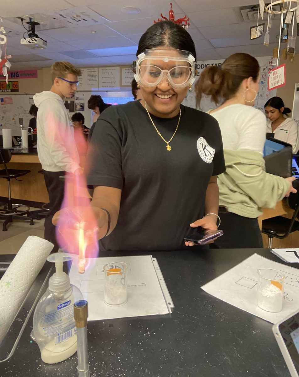 Puja Kotapati ‘26 turns a flame violet by putting it in contact with potassium in a Honors Chemistry spectroscopy lab Oct. 31. The lab focused on understanding the difference in energy within elements and how they affect visible light, as well as learning how to identify elements based on their spectrum. They looked through a spectroscope, a scientific tool that separates different colors of light, to view elements’ spectra. “The fire was so pretty,” Kotapati said. “My favorites were the teal and violet flames.”