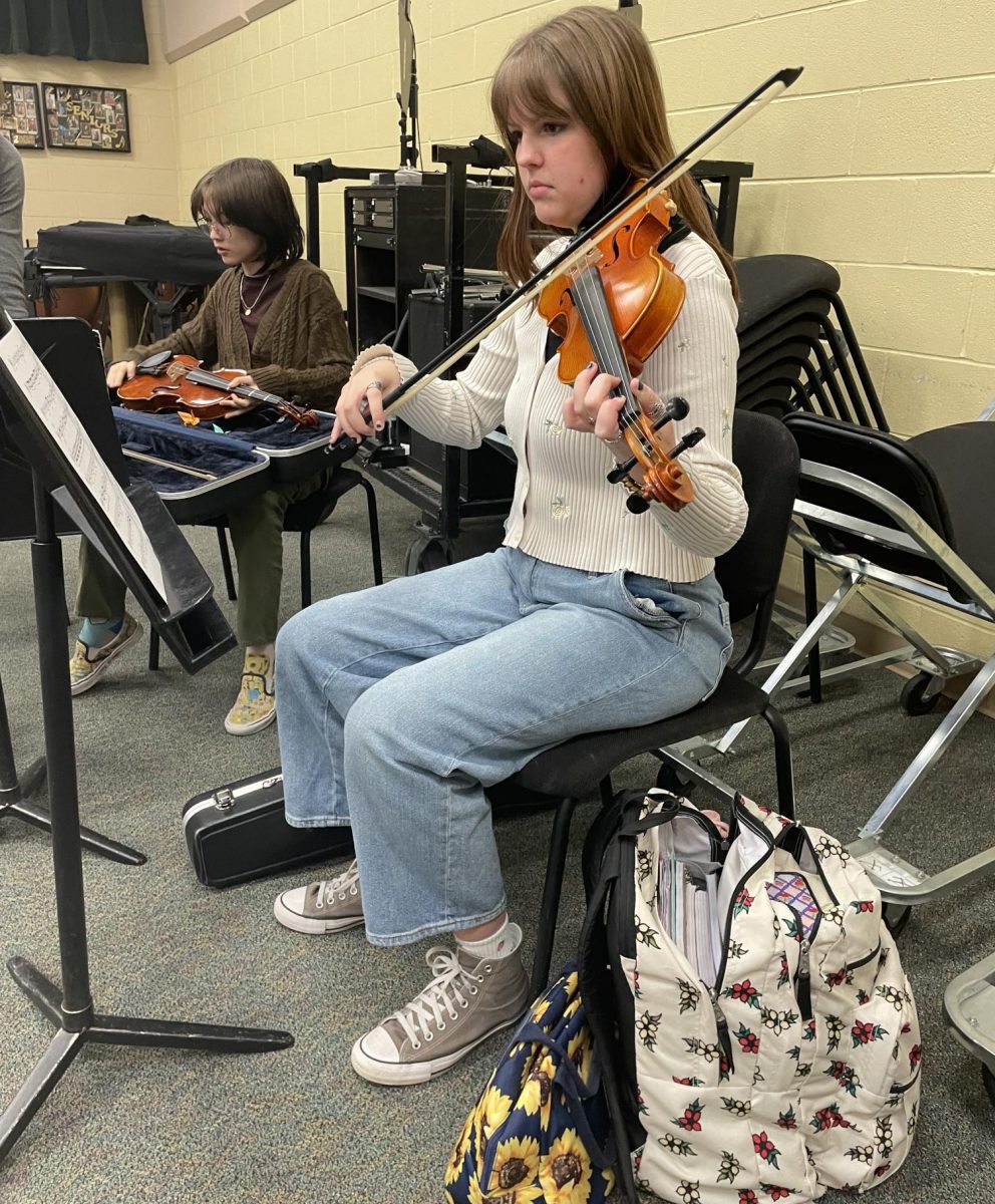 Brikelle Paxton ‘25 and Komi Edwards ‘26 practice their violins in the band room during Access Nov. 30. The annual musical concert, Jaguar Symphony, used the orchestra room to rehearse, so students who are not participating practiced in the band room. “The violin is a string instrument and I’ve been playing since I was six,” Paxton said. “I really enjoy being in orchestra and the community it creates.”