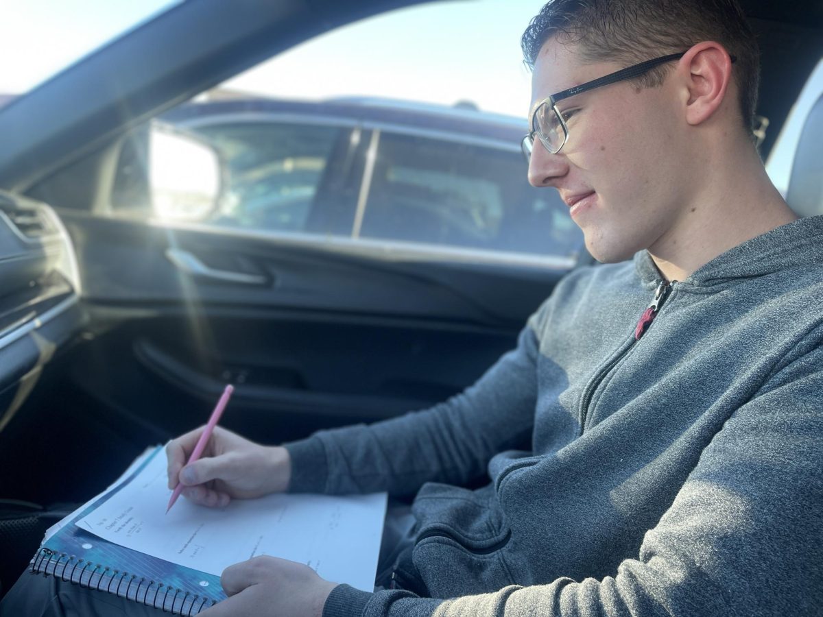 Devin Dexter ‘24 solves a practice problem on his Trigonometry final exam study guide in his car Dec. 7. Some students have begun preparing for finals in advance, including Dexter. This year, finals will take place from Monday, Dec. 18 to Thursday, Dec. 21. “I’m feeling excited to be done with the semester. I got a lot of study guides and materials I can use for my finals,” Dexter said.