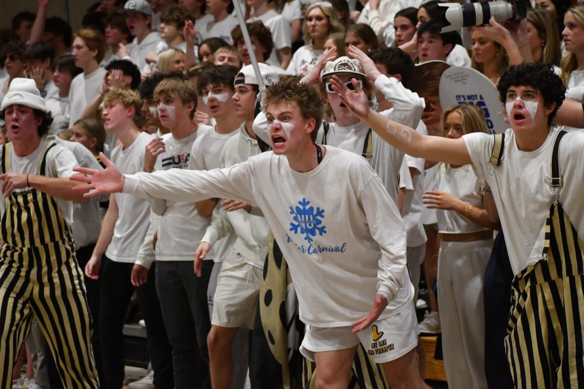 Aidan Brock ‘24 yells at referees after a call being a change of possession to Regis Jan.19. The student section theme for the game was whiteout, as announced on Instagram by @rcgoldenboys. 
