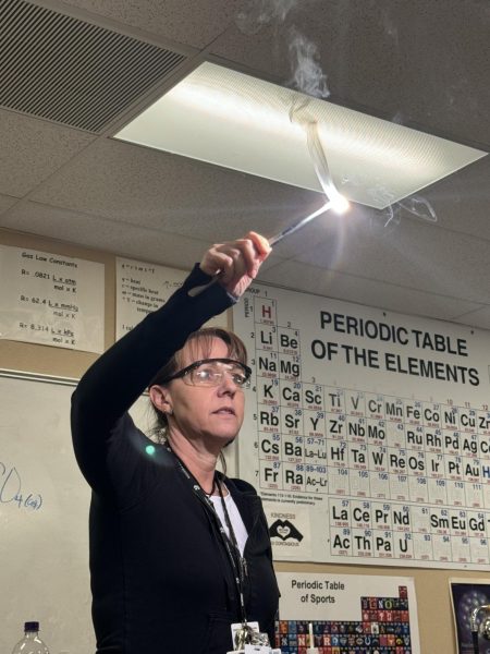Kerry Reilly illuminates the room with a bright chemical reaction in her Chemistry Honors class Feb. 15. The reaction, nicknamed White Lightning, demonstrated the reactive capabilities of magnesium.