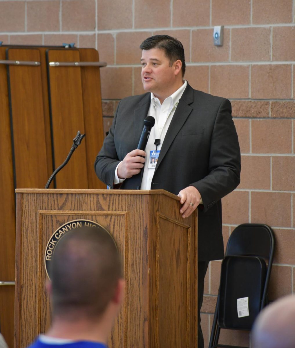In the cafeteria Feb. 7 at 7 a.m., Principal Andy Abner gives a speech to students and their families at the beginning of Signing Day. Coaches gave speeches on each of their athletes about their accomplishments and time on the team. 