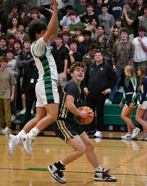 During the Jan. 26 basketball game at ThunderRidge, varsity point guard Hudson Ellwood ‘24 looks to score. Throughout this game, the Jags scored 48 points, while the Grizzlies only scored 44 points. “I think we’ve progressed a lot. There’s been a lot of ups and downs, but I think everything’s meshing together,” Ellwood said. 
