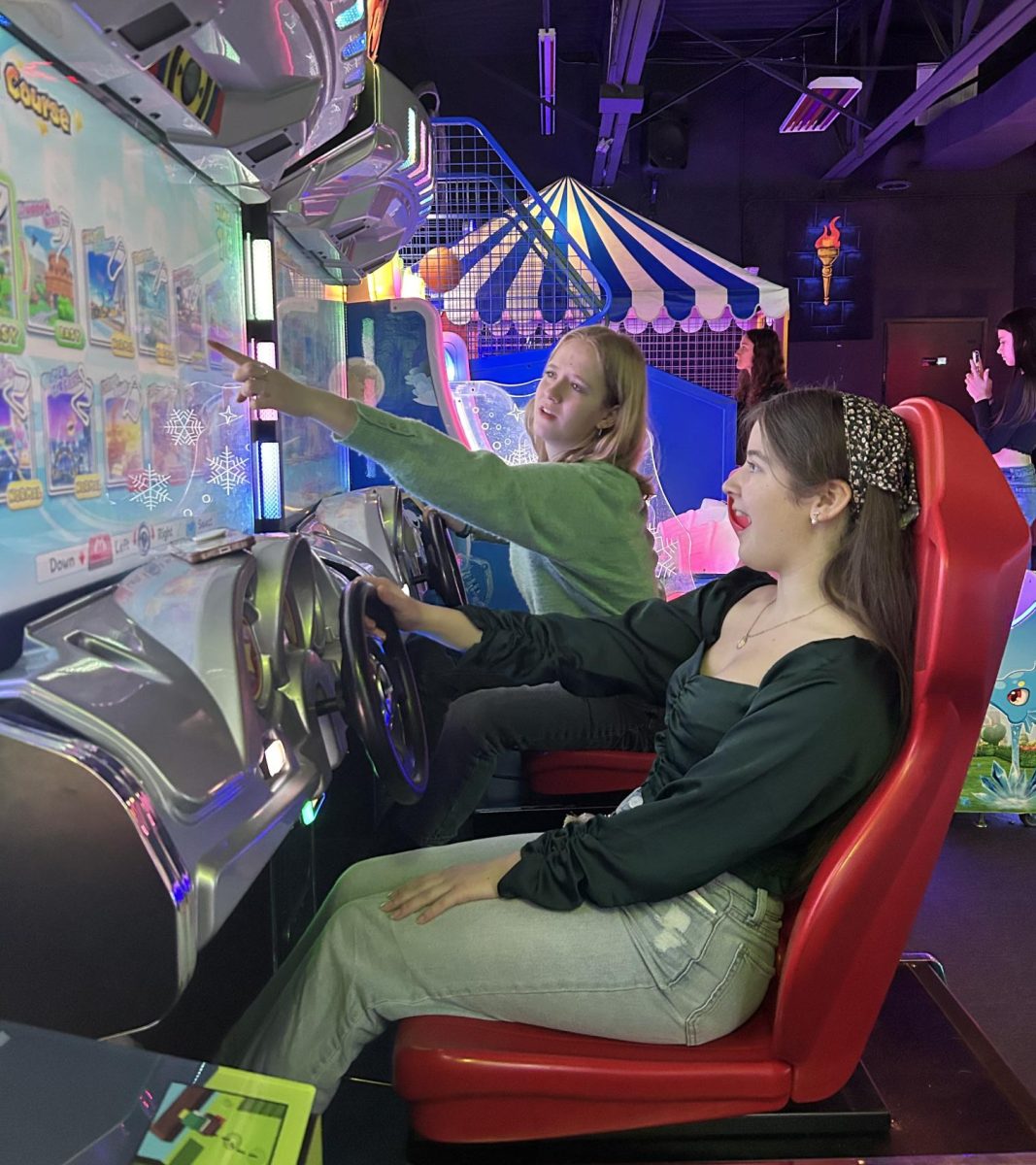 French National Honor Society (FNHS) members Greer Bezemek-Aguilar ‘25 and Ella Bearman ‘24 play Mario Kart in the arcade at Monster Mini Golf Feb. 9. FNHS students played mini golf and arcade games with French exchange students from noon to 2:30 p.m. as a way to get to know them and welcome them to the U.S. Eight exchange students will spend three weeks attending classes, practicing their English and learning about American culture by staying with host families and shadowing students around the school. “I was a little nervous going in to [meet] them. I’m not great with socializing with strangers but it was fun. They all seemed really nice,” Bearman said. “I’m looking forward to getting to know them better and learning about cultural differences in the American and French high school experiences.”