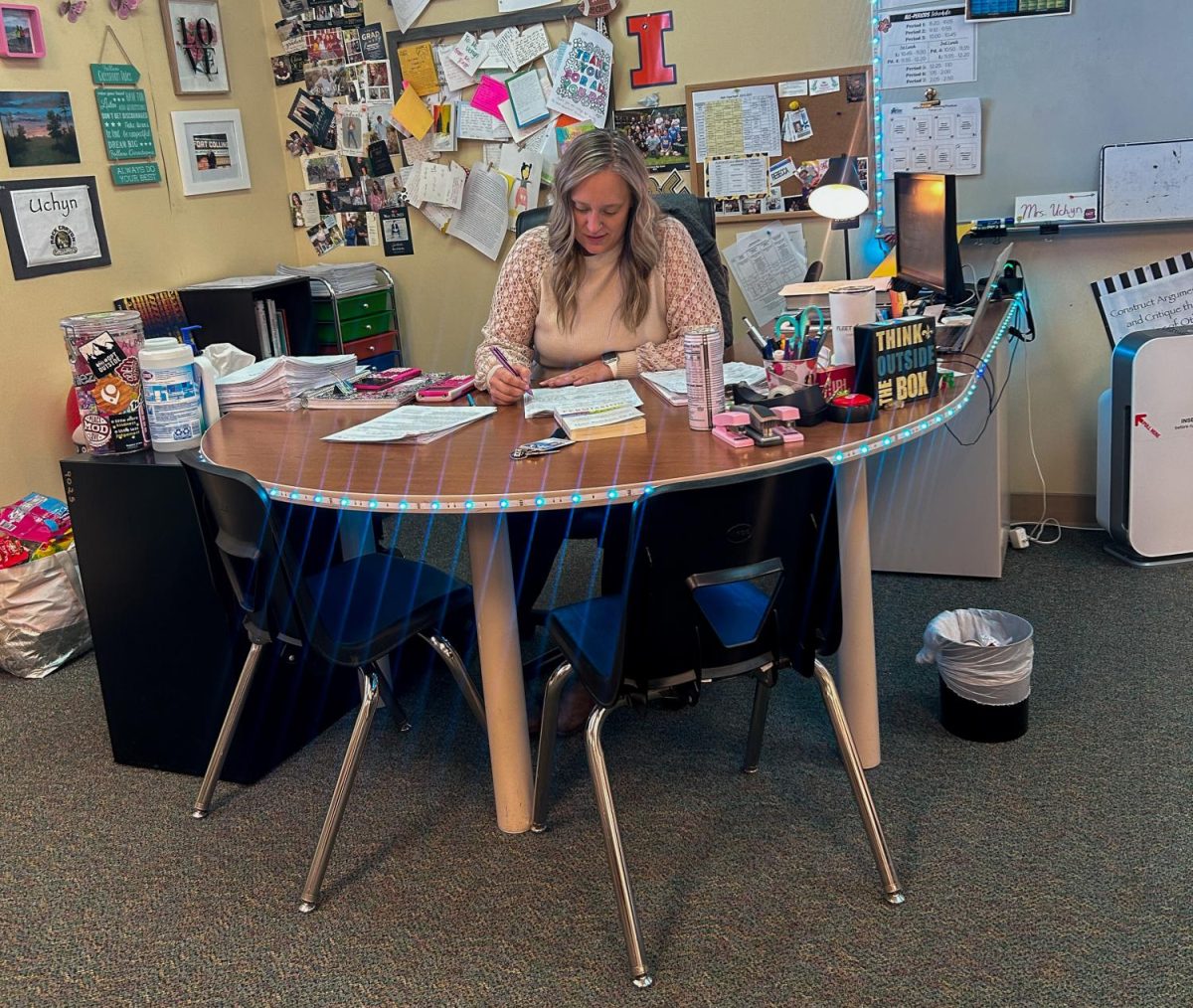 Rebecca Uchyn sits at her desk as she grades student work during seventh period AP Statistics Nov. 9. When she’s not up at the board teaching her class, Uchyn spends most of her time at her desk, where she is surrounded by decorations and lights. “I think a workspace is defined by the people in it. At Rock Canyon, the staff are incredibly dedicated to not just their students but also each other. We are supportive and encouraging through all the ups and downs of the school year. At the end of the day, work is work but being surrounded by really awesome people makes all the difference,” Uchyn said.